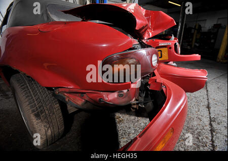 Car wreck. Crash damaged Mk1 Mazda MX5 with the rear bumper folded double after hitting a post backwards (no one was injured) Stock Photo