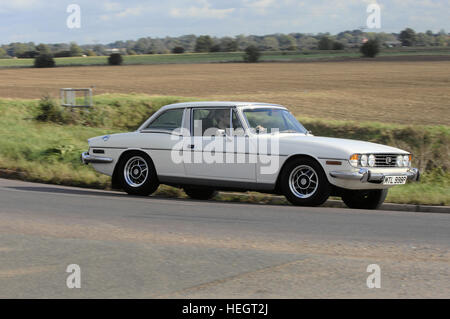 White Triumph Stag hardtop tracking action shot Stock Photo