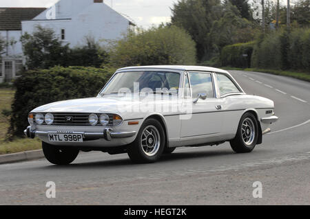 White Triumph Stag hardtop tracking action shot Stock Photo