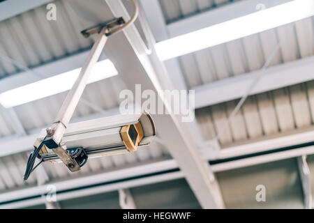 Surveillance security CCTV camera on the roof at night, safety or security concept Stock Photo