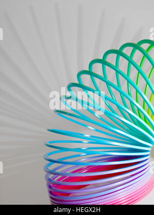 A rainbow coloured slinky children's toy. Stock Photo