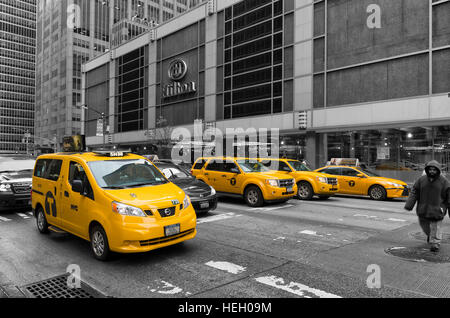 NEW YORK - MAY 3, 2016: Typically yellow medallion taxicabs in front of the New York Hilton. They are widely recognized icons of the city and come in Stock Photo