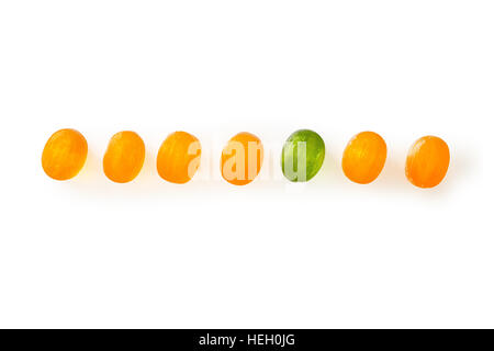 Row of small candies. Isolated on white with clipping path Stock Photo