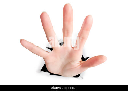 Female hand break through the paper. On white, wide angle view. Suddenness, overcome obstacles, surprise. breakthrough and catching concept Stock Photo