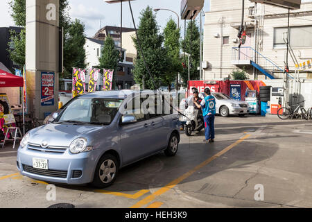 Vehicles at a petrol, gas, station in Tokyo, Japan. Stock Photo
