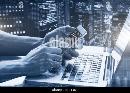 Double exposure of abstract financial graphs, business person in office using smartphone and laptop computer with stock market dashboard, and building Stock Photo