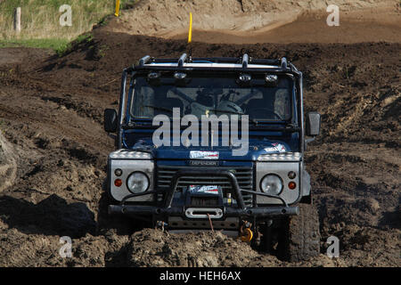 A Land Rover Defender 90 stuck in thick mud during a tough 4x4 off road challenge Stock Photo