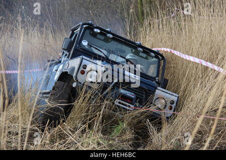 Land Rover Defender 90 winching from muddy swamp during a 4x4 off road challenge in Spaarnwoude, the Netherlands Stock Photo