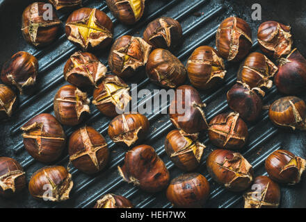 Roasted chestnut in frying pan on black stone background Stock Photo - Alamy