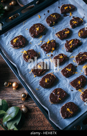 Dark chocolate and orange cookies on a baking tray Stock Photo