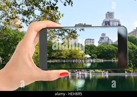 Tourist in Central Park of New York taking a shot of the beautiful landscape Stock Photo