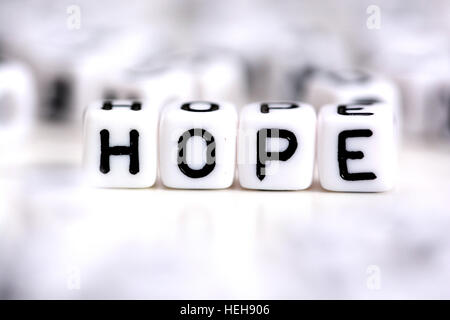 Hope word made from plastic alphabet blocks, stands in white background. Stock Photo