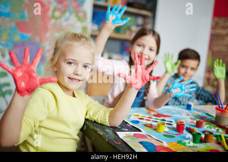 Elementary learners with hands in paint Stock Photo