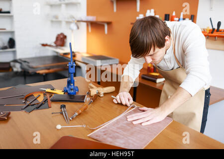 Master of tannery processing leather in workshop Stock Photo