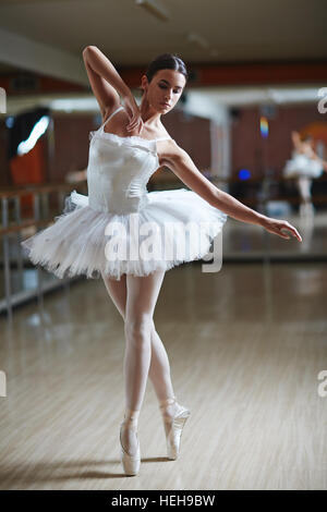 Ballet performer in white tutu dancing on stage Stock Photo