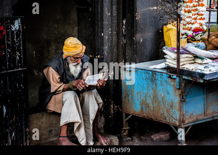A hindu sadhu reading his holy book. Stock Photo