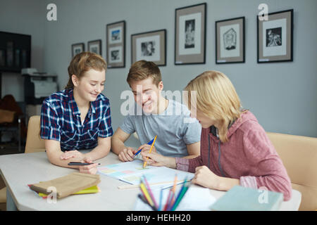 Three students sitting in college library after classes Stock Photo