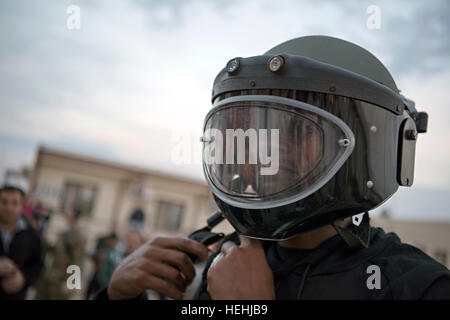 NBA basketball player Ray Allen tries on a military helmet and visor while visiting U.S. soldiers during a USO troop engagement tour at the Incirlik Air Base December 5, 2016 in Adana, Turkey. Stock Photo