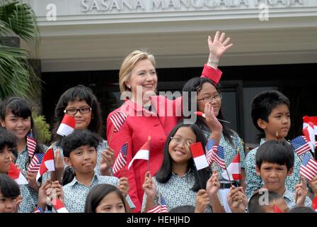 U.S. Secretary of State Hillary Clinton poses with children from the Menteng Elementary School Childrens Choir February 18, 2009 in Jakarta, Indonesia. Stock Photo