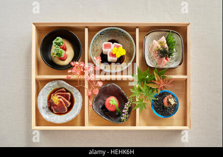 Japanese food wooden Bento box overhead view six dishes pretty bowls lunch traditional colourful beautiful delicious Stock Photo