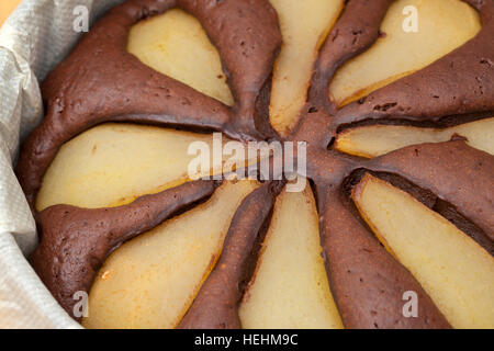 freshly made pear and chocolate cake in a round mold Stock Photo