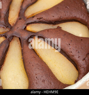 freshly made pear and chocolate cake in a round mold Stock Photo