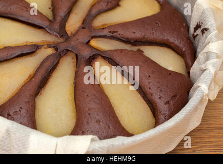 freshly made pear and chocolate cake in a round mold Stock Photo