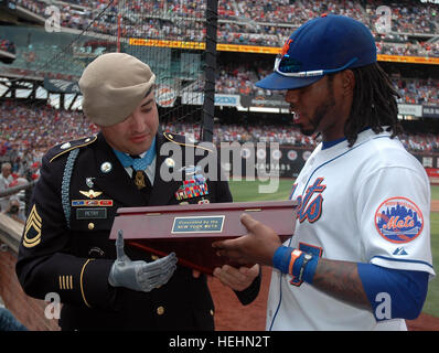 NEW YORK, NY – Sgt. 1st Class Leroy A. Petry, 75th Ranger Regiment Medal of Honor recipient, receives a plaque from the New York Mets and Jose Reyes, shortstop, during the third inning of the game against the Philadelphia Phillies, July 16. Petry was recognized on the big screen in the outfield and received a standing ovation from more than 30,000 fans attending the game. (Photo by Sgt. 1st Class Michael R. Noggle, USASOC Public Affairs) New York Mets Recognition Stock Photo