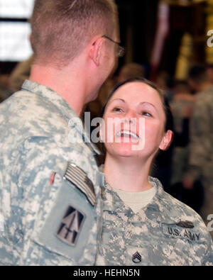 Indiana National Guard Staff Sgt. Rachel Jensen, 76th Brigade Special Troops Battalion, reunites with her boyfriend, Sgt. James Davis, senior medic for Troop A, 2-152 Infantry Battalion, both of Westfield, Ind., after returning home from deployment to Iraq with Indiana’s 219th Battlefield Surveillance Brigade, Tuesday, Nov. 29, 2011. Indiana Guardsmen return home from Iraq 493315 Stock Photo