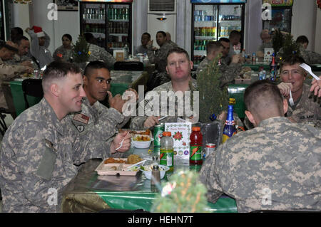 Soldiers of Company B, 1st Battalion, 27th Infantry Regiment Wolfhounds, 2nd Stryker Brigade Combat Team Warrior, 25th Infantry Division, currently attached to 3rd BCT, 4th Inf. Div., Multi-National Division-Baghdad enjoy a Christmas Day meal at the Forward Operating Base War Eagle dining facility in Baghdad. Wolfhounds celebrate Christmas in Iraq 138579 Stock Photo