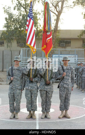 FORWARD OPERATING BASE RUSTAMIYAH, Iraq – The honor guard detachment assigned to 1st Battalion, 319th Airborne Field Artillery Regiment, 3rd Brigade Combat Team, 82nd Airborne Division, Multi-National Division – Baghdad hold the national and battalion colors side by side representing the transition between the Paratroopers of 1st Battalion, 319th Airborne Field Artillery Regiment, based out of Fort Bragg, N.C., and Soldiers of the 5th Battalion, 25th Field Artillery Regiment, 4th Brigade Combat Team, 10th Mountain Division on Dec 31 at Forward Operating Rustamiyah. The 1st Battalion, 319th Air Stock Photo