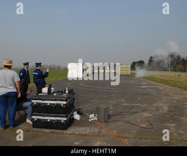 Mr. Brandon Howard, seated, and Mr. Luis Velez, from Benelux Training Support Center, is conducting a demonstration of a training improvised explosive device, to a Belgian Federal Police team, during the grand opening of the new Alliance Home Station Training Area, on Chi?vres Air Base, in Chi?vres, Belgium, March 17, 2009. (U.S. Army photo by Pierre-Etienne Courtejoie/Released) US Army 52870 Title Stock Photo