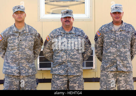 GUANTANAMO BAY, Cuba – Army Spc. Jonathan Santiago, Army Staff Sgt. Jose Santiago and Army Sgt. Joseph Santiago are deployed to Joint Task Force Guantanamo with the Puerto Rico National Guard, March 26, 2009. Jonathan and Joseph both volunteered to join the mission at JTF Guantanamo when they learned their father’s unit was being deployed here. JTF Guantanamo conducts safe, humane, legal and transparent care and custody of detainees, including those convicted by military commission and those ordered released. The JTF conducts intelligence collection, analysis and dissemination for the protecti Stock Photo