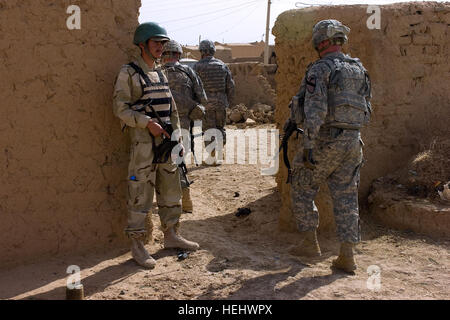An Iraqi soldier provides security, as U.S. Soldiers from Crazyhorse Troop, 4th Squadron, 9th Cavalry Regiment, 2nd Heavy Brigade Combat Team, 1st Cavalry Division, Fort Hood, Texas, enters the village of Jambur, on April 28, in Kirkuk, Iraq. Patrol in Kirkuk, Iraq 168959 Stock Photo