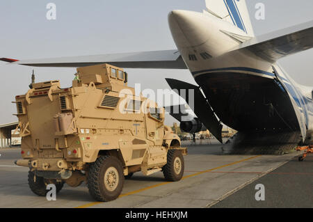 Mine Resistant Ambush Protected Maxx Pro vehicles are loaded onto a transport aircraft in support of the responsible drawdown of U.S. forces in Iraq. The 62nd Chemical Company provides the security for the vehicles throughout the flight. 62nd Chemical Company Escorts MRAPS Going Into Afghanistan 286935 Stock Photo