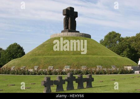 U.S., French, Canadian, and German Soldiers gather to remember the fallen together at a stone statue of a woman mourning her lost family at the La Cambe German war cemetery located near the town of La Cambe in Calvados, France, June 5, 2009. This cemetery is for burial of German soldiers killed during the Normandy invasion on June 6, 1944. (U.S. Army Photo by Alfredo Barraza Jr./Released) La Cambe War Cemetery (2009) Stock Photo