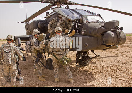 Soldiers of Company F, 3rd Battalion, 1st Air Cavalry Brigade, 1st Cavalry Division, Multi-National Division - Baghdad, remove the crew members from an AH-64D Apache attack helicopter during a downed aircraft training exercise at Camp Taji, Iraq, north of Baghdad, June 10. The 1st ACB ran the drill to fine tune the process of crew rescue and aircraft recovery. 1st Air Cavalry Brigade conducts fallen angel training 179061 Stock Photo