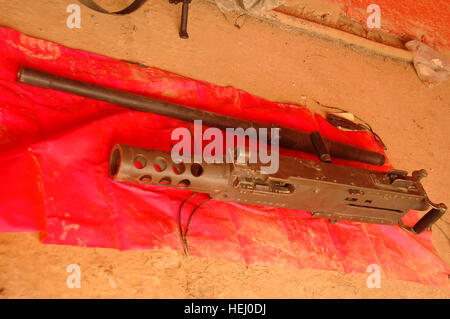 An M2 Browning 50 caliber machine gun belonging to the 1st Battalion, 5th Cavalry Regiment, 2nd Brigade Combat Team, 1st Cavalry Division lies on a red towel ready to be used as a training aid at Joint Security Station War Eagle, near Baghdad, Iraq, July 13. Machine Gun Training 187489 Stock Photo