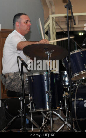 Staff Sgt. John Desorchers, Manchester, N.H., percussionist, 39th Army Band, N.H. National Guard, plays the drums during the 39th Army Band’s July Fourth concert at Camp Arifjan. Third Army hosted the 39th Army Band to celebrate Independence Day and to recognize service members working hard to both sustain the fight others have worked for, and to shape the future of U.S. operations in Kuwait. Third Army hosts 39th Army Band 110704-A-HZ286-059 Stock Photo