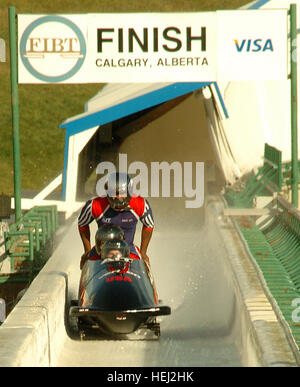 0608-SHfinish.jpg: Spc. Steve Holcomb, along with teammates Ivan Radcliff, Brock Kreitzburg and Curt Tomasevicz cross the bobsled track finish line at Canada Olympic Park in Calgary, Canada, during the final day of U.S. National Bobsled Team trials. Holcomb was named the U.S. national four-man bobsled champion after competitions here Oct. 22 and 23. He beat eight other drivers for the title, posting the fastest run time of the event on day one and best two-out-of-three combined time on both days. The title gives Holcomb the right to pilot USA I during four-man World Cup competitions leading up Stock Photo