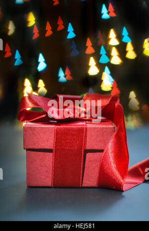 Red present box with Christmas tree shaped bokeh lights Stock Photo