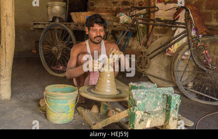 A village potter is making tea pots at his home in Durgapur, West bengal, India. on November 12,2016. Stock Photo
