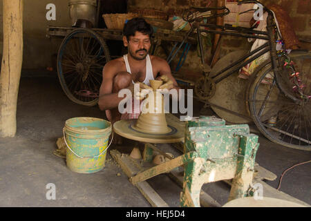 A village potter is making tea pots at his home in Durgapur, West bengal, India. on November 12,2016. Stock Photo