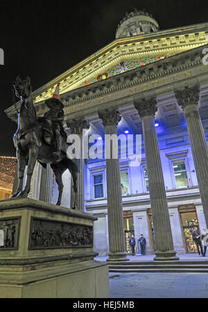 Glasgow buildings of the Merchant City,Scotland,UK at night - GOMA and traffic cone on head of Duke Of Wellington Stock Photo