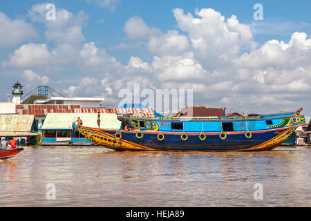 Wooden boats and floating houses in Musi riverbank, South Sumatra, Indonesia. Stock Photo