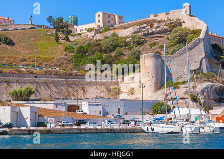 Bonifacio, France - July 2, 2015: Ancient coastal citadel of Bonifacio, small resort port city of Corsica island in sunny summer day. Sailing yachts a Stock Photo