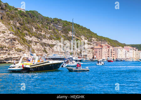 Bonifacio, France - July 2, 2015: Pleasure yacht with ordinary tourists enters the port  of Bonifacio, small resort port city of Corsica island Stock Photo