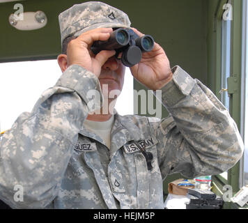 GUANTANAMO BAY, Cuba – Army Pfc. Luis Rodriguez, a light wheel mechanic with Joint Task Force Guantanamo's 480th Military Police Company, scans the Cuban horizon, Oct. 7, 2009. The 480th MP Company, part of the 525th Military Police Battalion, provides external security to the JTF and supports the guard force inside the detention facilities. JTF Guantanamo conducts safe, humane, legal and transparent care and custody of detainees, including those convicted by military commission and those ordered released by a court. The JTF conducts intelligence collection, analysis and dissemination for the  Stock Photo