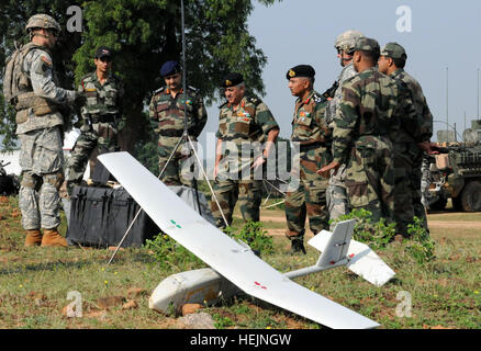 CAMP BUNDELA, India (Oct. 16, 2009) – Spc. David Swan, infantryman, Troop B, 2nd Squadron, 14th Cavalry Regiment, 'Strykehorse,' 2nd Stryker Brigade Combat Team, 25th Infantry Division, explains how an Unmanned Aerial Vehicle operates to Indian Army Maj. Gen. Anil Malik (center), commander, 31st Armored Division, during Exercise Yudh Abhyas 09in Babina India, Oct. 16. YA09 is a bilateral exercise involving the Armies of India and the United States. The Indian and U. primary goal of the exercise is to develop and expand upon the relationship between S. Army. US Army 53500 Strykehorse Soldiers s Stock Photo