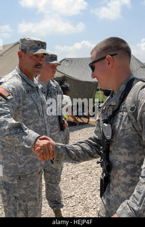 Maj. Gen. Simeon Trombitas, commanding general, Joint Task Force-Haiti, shakes hands with a Soldier from 2-325 Airborne infantry Regiment as he boards a plane home to Fort Bragg, N.C., May 5. This group of paratroopers signified the last troops on the ground from the 82nd Airborne Division in Haiti. Departure From Haiti 276015 Stock Photo